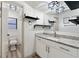 Clean bathroom with granite countertop and floating shelves at 1422 Tierra Cir, Winter Park, FL 32792