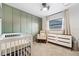 Bedroom with crib, rocker, and dresser; neutral color scheme at 1422 Tierra Cir, Winter Park, FL 32792