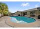 Relaxing kidney-shaped pool in a sunny backyard at 1422 Tierra Cir, Winter Park, FL 32792