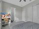 Comfortable bedroom with large bed, TV, and double door closet at 15155 Mayberry Dr, Winter Garden, FL 34787