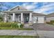 Beautiful two-story home with gray exterior, white columns, and a two-car garage at 15155 Mayberry Dr, Winter Garden, FL 34787