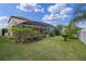 Large backyard with covered patio and lush lawn at 1827 Pisgah Ln, Apopka, FL 32712