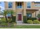 Front entrance with a red door, landscaping, and a walkway at 1827 Pisgah Ln, Apopka, FL 32712