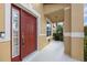Red front door with sidelights and a small covered porch at 1827 Pisgah Ln, Apopka, FL 32712