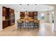 Kitchen with dark brown cabinets, island with seating, and stainless steel appliances at 1827 Pisgah Ln, Apopka, FL 32712