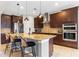 Spacious kitchen with granite countertops, stainless steel appliances, and dark wood cabinets at 1827 Pisgah Ln, Apopka, FL 32712