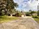 Brick ranch home with long driveway and mature trees at 227 N Kepler Rd, Deland, FL 32724