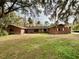 Ranch style brick home with large yard and mature trees at 227 N Kepler Rd, Deland, FL 32724