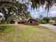 Ranch style brick home with large yard and mature trees at 227 N Kepler Rd, Deland, FL 32724