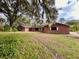 Ranch style brick home with large yard and mature trees at 227 N Kepler Rd, Deland, FL 32724