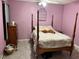 Bedroom with a post bed, ceiling fan, and purple walls at 262 Scottsdale Sq # 262, Winter Park, FL 32792
