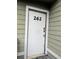 White front door of the condo building with the number 262 at 262 Scottsdale Sq # 262, Winter Park, FL 32792