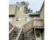 Exterior view of a light green two-story building with stairs and a wreath on the door at 262 Scottsdale Sq # 262, Winter Park, FL 32792