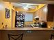 Kitchen with cabinets, appliances, and breakfast bar at 262 Scottsdale Sq # 262, Winter Park, FL 32792