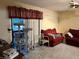 Living room with red couches, cat tree, and sliding glass doors at 262 Scottsdale Sq # 262, Winter Park, FL 32792
