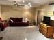 Living room with tile floors, red couches, and a wooden dresser at 262 Scottsdale Sq # 262, Winter Park, FL 32792