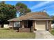 Charming single-story home with a brick facade and attached garage at 3153 Berridge Ln, Orlando, FL 32812