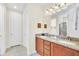 Double vanity bathroom with granite countertops and shower at 611 Lasso Dr, Kissimmee, FL 34747