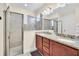 Double vanity bathroom with granite countertop and shower at 611 Lasso Dr, Kissimmee, FL 34747