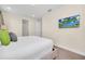 Bright bedroom with a queen bed, TV, and access to a private bathroom at 611 Lasso Dr, Kissimmee, FL 34747