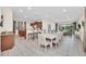 Open concept dining room with large table and adjacent kitchen at 611 Lasso Dr, Kissimmee, FL 34747