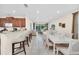 Open concept dining room with large table and adjacent kitchen at 611 Lasso Dr, Kissimmee, FL 34747