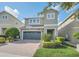 Two-story house with a green door and paved driveway at 611 Lasso Dr, Kissimmee, FL 34747