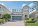 Two-story house with a green door and paved driveway at 611 Lasso Dr, Kissimmee, FL 34747