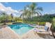 Relaxing pool area with lounge chairs and tropical landscaping at 611 Lasso Dr, Kissimmee, FL 34747
