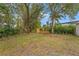 Partially fenced backyard with mature trees at 6829 Bittersweet Ln, Orlando, FL 32819