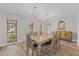 Modern dining room with chandelier and hardwood floors at 6829 Bittersweet Ln, Orlando, FL 32819