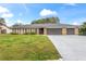 Brick house with 3-car garage, and a spacious lawn at 6829 Bittersweet Ln, Orlando, FL 32819