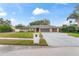 Single-story home with three-car garage and landscaped yard at 6829 Bittersweet Ln, Orlando, FL 32819