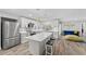 Bright kitchen boasts white cabinets, quartz countertops, and stainless steel appliances at 6829 Bittersweet Ln, Orlando, FL 32819