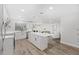 Modern kitchen with white cabinets, island, and stainless steel appliances at 6829 Bittersweet Ln, Orlando, FL 32819