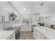 Modern kitchen with white cabinets, island, and stainless steel appliances at 6829 Bittersweet Ln, Orlando, FL 32819