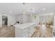 Open concept kitchen with white cabinets, quartz countertops, and island at 6829 Bittersweet Ln, Orlando, FL 32819