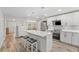 Updated kitchen with white cabinets, quartz countertops, and an island with seating at 6829 Bittersweet Ln, Orlando, FL 32819