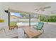 Covered patio with ceiling fans, comfortable seating, and pool view at 6829 Bittersweet Ln, Orlando, FL 32819