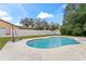 Inviting kidney-shaped pool with surrounding patio and lush landscaping at 6829 Bittersweet Ln, Orlando, FL 32819