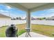 Covered patio overlooks a fenced-in backyard at 1002 Cannock Dr, Kissimmee, FL 34758