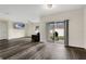 Living room with sliding doors to patio and wood-look floors at 1002 Cannock Dr, Kissimmee, FL 34758