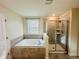 Spa-like bathroom with soaking tub and walk-in shower at 10118 Storey Grove Way, Winter Garden, FL 34787