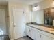 Double vanity bathroom with a large mirror and shower at 10118 Storey Grove Way, Winter Garden, FL 34787
