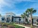 Community clubhouse with palm trees and festive decor at 10118 Storey Grove Way, Winter Garden, FL 34787