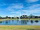 Serene community lake with a water fountain at 10118 Storey Grove Way, Winter Garden, FL 34787