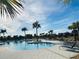 Large community pool with plenty of lounge chairs and palm trees at 10118 Storey Grove Way, Winter Garden, FL 34787