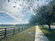 Peaceful walkway with scenic views and a wooden fence at 10118 Storey Grove Way, Winter Garden, FL 34787