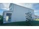 Side view of two-story house, gray siding, and covered porch at 10118 Storey Grove Way, Winter Garden, FL 34787