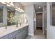 Elegant bathroom with double vanity, large mirror, and shower at 1104 Western Blue Way, Minneola, FL 34715